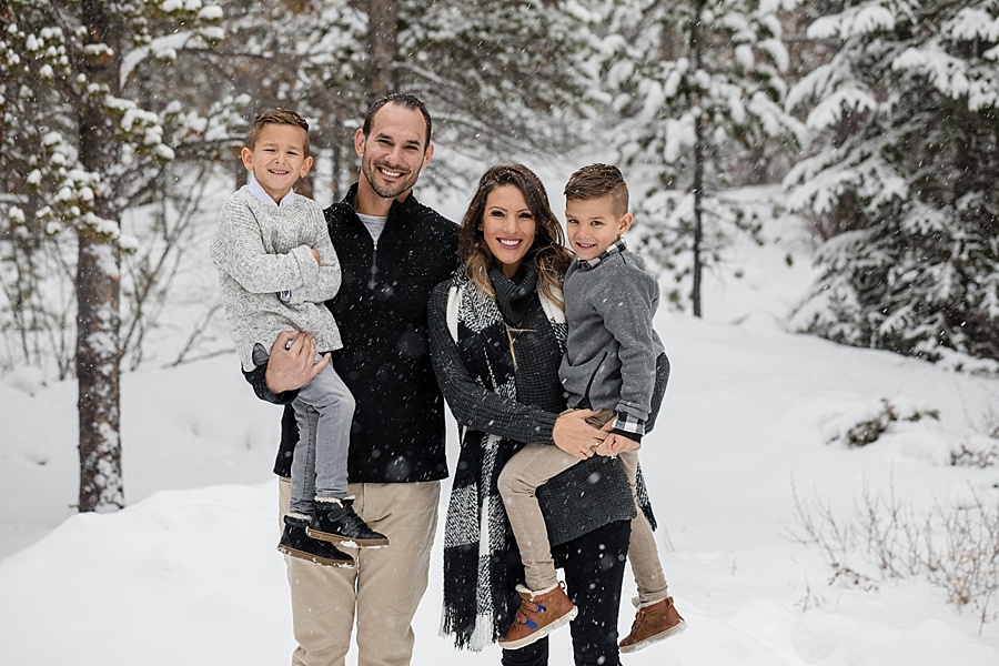 cute family wearing grey pose in the snow in Breckenridge Colorado 