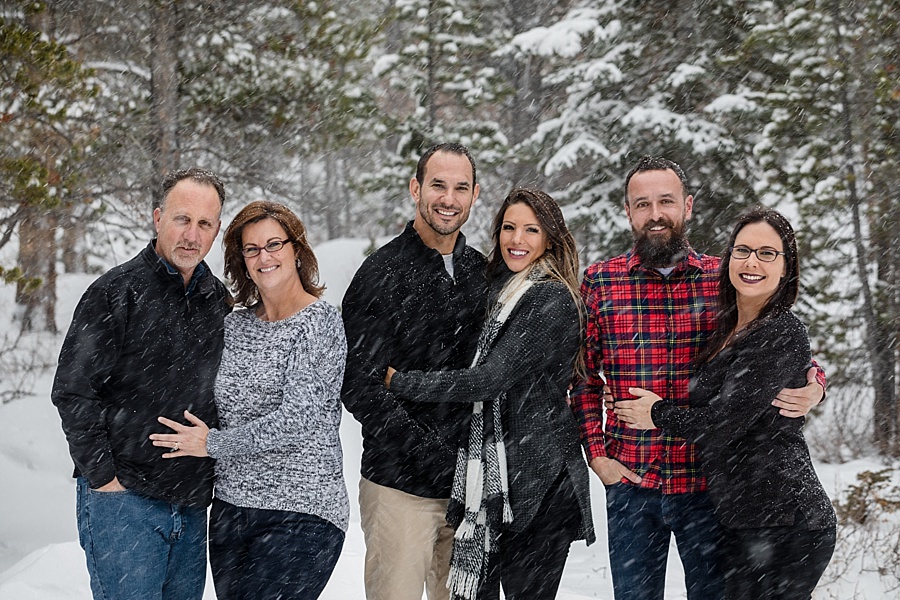 three sibling couples pose in the snow in Colorado