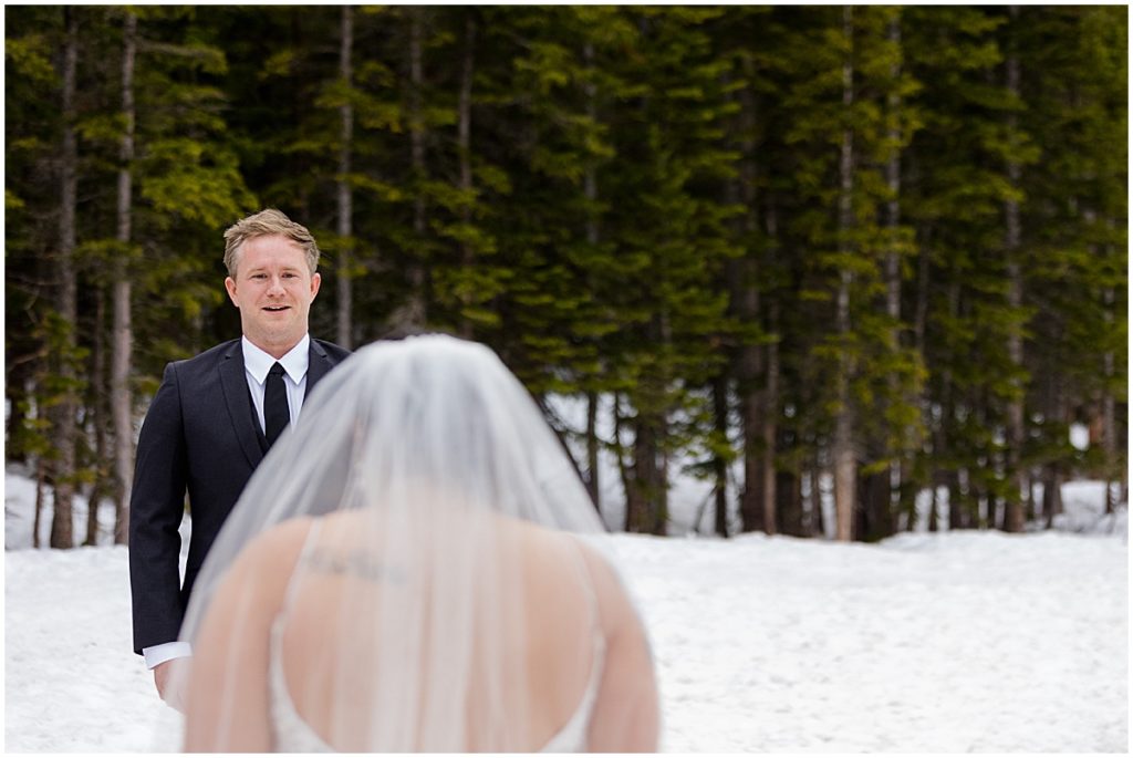 Groom seeing bride at elopement at Rocky Mountain National Park