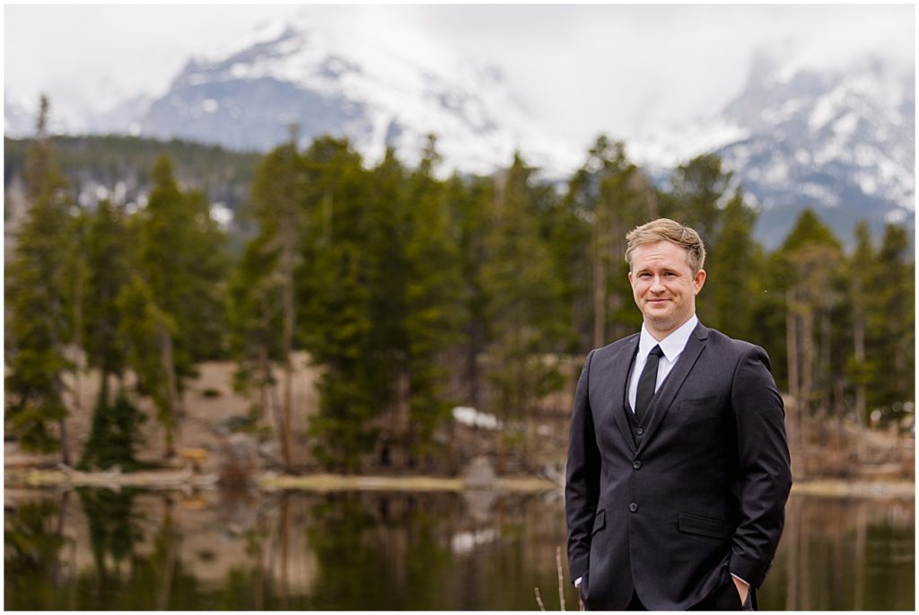 Groom at lake Sprague during elopement at Rocky Mountain National Park