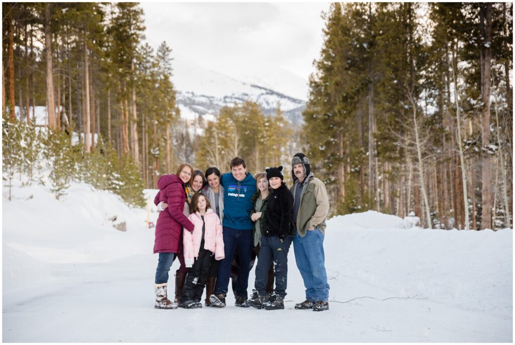 large family posing in the snowy Colorado mountains in Breckenridge