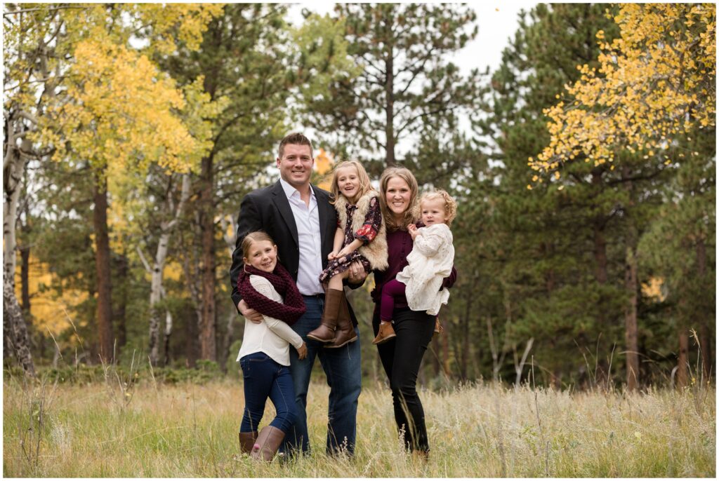 amily poses together in meadow in conifer Colorado